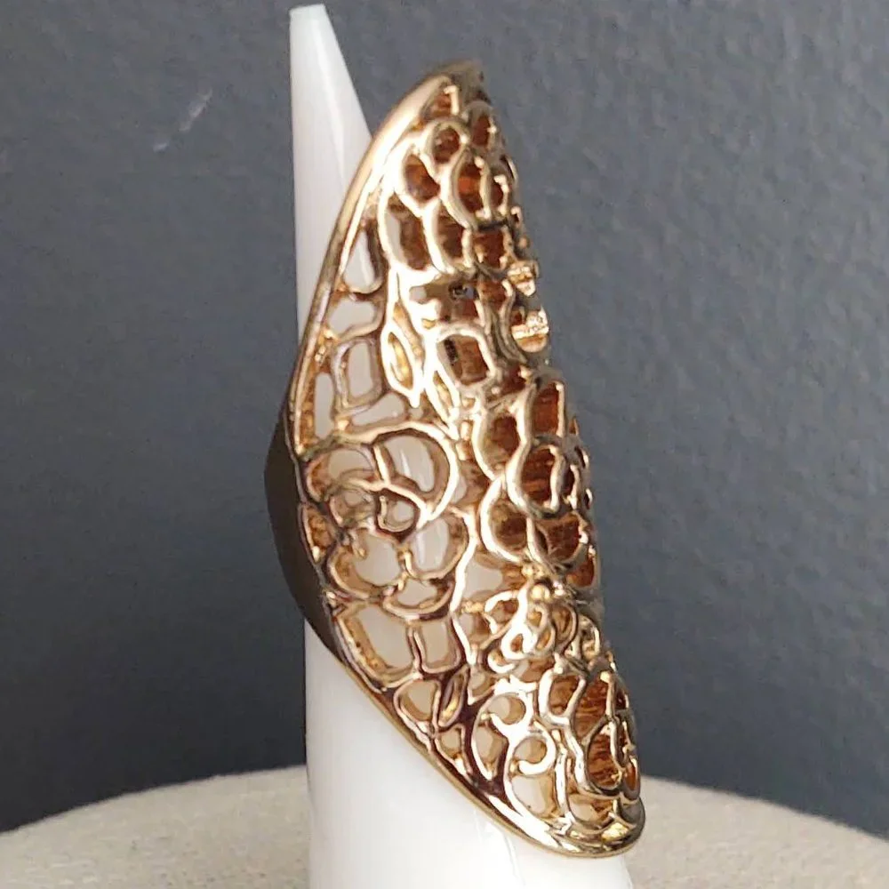 Long, open scroll design gold ring